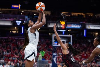Sep 26, 2025; Indianapolis, Indiana, USA; Las Vegas Aces guard Jackie Young (0) shoots the ball while Indiana Fever guard Kelsey Mitchell (0) defends during game three of the second round for the 2025 WNBA Playoffs at Gainbridge Fieldhouse. Mandatory Credit: Trevor Ruszkowski-Imagn Images