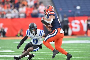 Sep 27, 2025; Syracuse, New York, USA; Duke Blue Devils cornerback Chandler Rivers (0) tries to tackle Syracuse Orange running back Will Nixon (24) in the second quarter at the JMA Wireless Dome. Mandatory Credit: Mark Konezny-Imagn Images