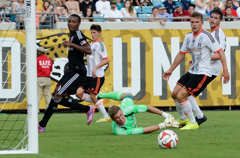 Jul 26, 2014; Jacksonville, FL, USA; Fulham FC goalie Jesse Joronen (41) makes a diving save against D.C. United forward Michael Seaton (29) at EverBank Field. Mandatory Credit: Richard Dole-Imagn Images