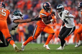 Nov 14, 2021; Denver, Colorado, USA; Denver Broncos running back Javonte Williams (33) carries the ball in the third quarter against the Philadelphia Eagles at Empower Field at Mile High. Mandatory Credit: Ron Chenoy-Imagn Images