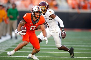 Oklahoma State's Ollie Gordon (0) rushes after a reception as Central Michigan's Trey Jones (3) defends in the second quarter during the college football game between the Oklahoma State Cowboys and Central Michigan Chippewa at Boone Pickens Stadium in Stillwater, Oka., Thursday, Sept., 1, 2022. OSU won 58-44.

Osu Vs Central Michigan