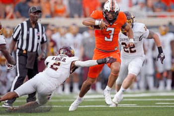Oklahoma State's Spencer Sanders (3) get by Central Michigan's Ronald Kent Jr. (2) on his way to a touchdown in first quarter during the college football game between the Oklahoma State Cowboys and Central Michigan Chippewa at Boone Pickens Stadium in Stillwater, Oka., Thursday, Sept., 1, 2022. OSU won 58-44.

Osu Vs Central Michigan