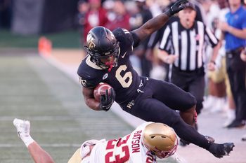 Oct 22, 2022; Winston-Salem, North Carolina, USA;  Wake Forest Demon Deacons running back Justice Ellison (6) is brought down by Boston College Eagles defensive back Cole Batson (23) during the second half at Truist Field. Mandatory Credit: Reinhold Matay-Imagn Images