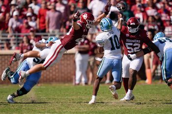 Oklahoma Sooners defensive lineman Ethan Downs (40) leaps at Tulane Green Wave quarterback Darian Mensah (10) beside defensive lineman Damonic Williams (52) during a college football game between the University of Oklahoma Sooners (OU) and the Tulane Green Wave at Gaylord Family - Oklahoma Memorial Stadium in Norman, Okla., Saturday, Sept. 14, 2024.