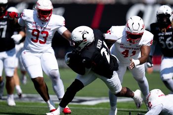 Cincinnati Bearcats running back Corey Kiner (21) breaks a tackle attempt in the second quarter of the College Football game against the Houston Cougars at Nippert Stadium in Cincinnati on Saturday, Sept. 21, 2024.