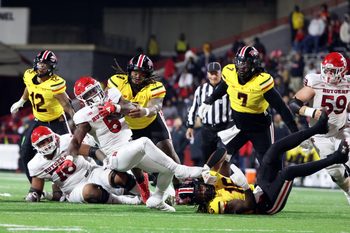 Nov 16, 2024; College Park, Maryland, USA; Maryland Terrapins defensive lineman Jordan Phillips (8) and linebacker Daniel Wingate (16) tackle Rutgers Scarlet Knights wide receiver KJ Duff (8) during the second half at SECU Stadium. Mandatory Credit: Daniel Kucin Jr.-Imagn Images