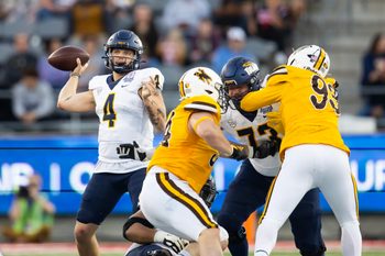 Dec 30, 2023; Tucson, AZ, USA; Toledo Rockets quarterback Tucker Gleason (4) against the Wyoming Cowboys in the Arizona Bowl at Arizona Stadium. Mandatory Credit: Mark J. Rebilas-USA TODAY Sports