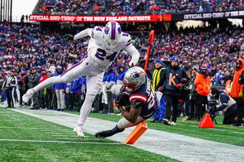 Jan 5, 2025; Foxborough, Massachusetts, USA; New England Patriots running back Terrell Jennings (26) looses control of the ball in the end zone against Buffalo Bills safety Cole Bishop (24) in the second half at Gillette Stadium. Mandatory Credit: David Butler II-Imagn Images