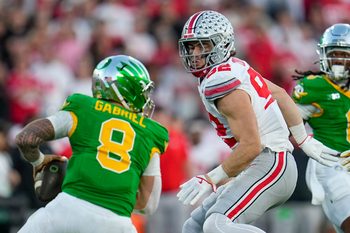 Ohio State Buckeyes defensive end Caden Curry (92) pursues Oregon Ducks quarterback Dillon Gabriel (8) during the College Football Playoff quarterfinal at the Rose Bowl in Pasadena, Calif. on Jan. 1, 2025. Ohio State won 41-21.