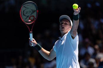 Jan 14, 2025; Melbourne, Victoria, Australia; Jenson Brooksby of United States of America serves during his match against Taylor Fritz of United States of America in the first round of the men's singles at the 2025 Australian Open at Melbourne Park. Mandatory Credit: Mike Frey-Imagn Images
