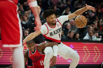 Jan 16, 2025; Portland, Oregon, USA; Portland Trail Blazers guard Shaedon Sharpe (17) and LA Clippers guard Kris Dunn (8) get tangled up chasing a loose ball during the second half at Moda Center. Mandatory Credit: Troy Wayrynen-Imagn Images