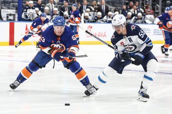 Mar 4, 2025; Elmont, New York, USA;  New York Islanders center Casey Cizikas (53) and Winnipeg Jets center Mark Scheifele (55) chase after the puck in the second period at UBS Arena. Mandatory Credit: Wendell Cruz-Imagn Images