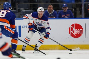 Mar 14, 2025; Elmont, New York, USA; Edmonton Oilers center Connor McDavid (97) controls the puck against the New York Islanders during the first period at UBS Arena. Mandatory Credit: Thomas Salus-Imagn Images