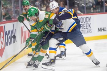 Mar 15, 2025; Saint Paul, Minnesota, USA; St. Louis Blues center Jordan Kyrou (25) catches the elbow of Minnesota Wild center Frederick Gaudreau (89) while playing the puck behind the Minnesota Wild net in the first period at Xcel Energy Center. Mandatory Credit: Matt Blewett-Imagn Images