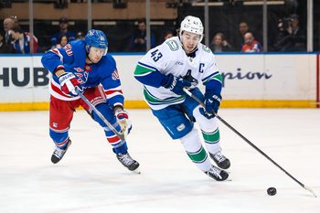 Mar 22, 2025; New York, New York, USA; New York Rangers left wing Will Cuylle (50) chases Vancouver Canucks defenseman Quinn Hughes (43) during the third period at Madison Square Garden. Mandatory Credit: Danny Wild-Imagn Images