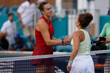 Mar 27, 2025; Miami, FL, USA; Aryna Sabalenka (L) shakes hands with Jasmine Paolini (ITA)(R) at the net after their women's singles semifinal on day ten of the Miami Open at Hard Rock Stadium. Mandatory Credit: Geoff Burke-Imagn Images