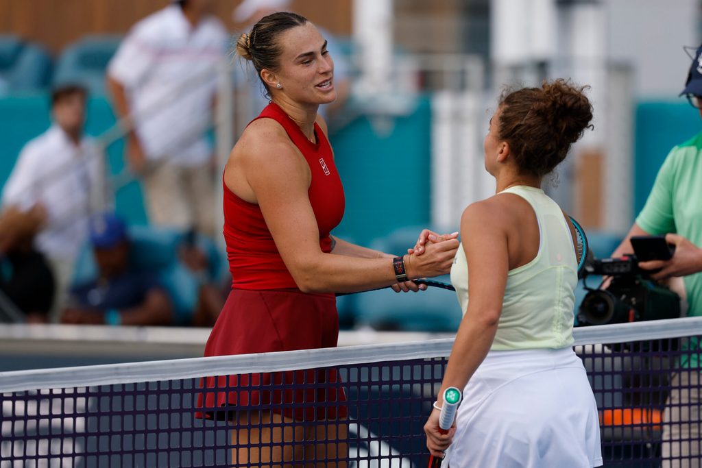 Mar 27, 2025; Miami, FL, USA; Aryna Sabalenka (L) shakes hands with Jasmine Paolini (ITA)(R) at the net after their women's singles semifinal on day ten of the Miami Open at Hard Rock Stadium. Mandatory Credit: Geoff Burke-Imagn Images