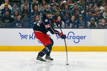Mar 28, 2025; Columbus, Ohio, USA; Columbus Blue Jackets right wing Kirill Marchenko (86) wrists a shot on goal against the Vancouver Canucks during the first period at Nationwide Arena. Mandatory Credit: Russell LaBounty-Imagn Images