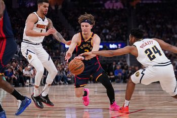 Apr 4, 2025; San Francisco, California, USA;  Golden State Warriors guard Brandin Podziemski (2) dribbles by Denver Nuggets forward Michael Porter Jr. (1) and Denver Nuggets guard Jalen Pickett (24) in the third period at Chase Center. Mandatory Credit: David Gonzales-Imagn Images