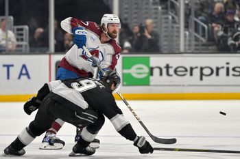 Apr 12, 2025; Los Angeles, California, USA; Los Angeles Kings right wing Adrian Kempe (9) defends a pass by Colorado Avalanche defenseman Keaton Middleton (67) during the third period at Crypto.com Arena. Mandatory Credit: Jayne Kamin-Oncea-Imagn Images