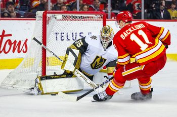 Apr 15, 2025; Calgary, Alberta, CAN; Vegas Golden Knights goaltender Ilya Samsonov (35) makes a save against Calgary Flames center Mikael Backlund (11) during the overtime period at Scotiabank Saddledome. Mandatory Credit: Sergei Belski-Imagn Images