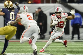 Ohio State Buckeyes running back TreVeyon Henderson (32) runs during the College Football Playoff National Championship against the Notre Dame Fighting Irish at Mercedes-Benz Stadium in Atlanta on Jan. 22, 2025.