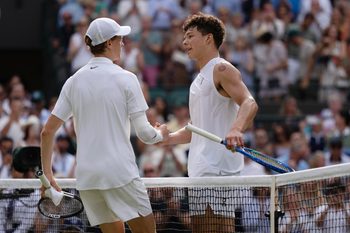 Jul 9, 2025; Wimbledon, United Kingdom; Jannik Sinner of Italy at the net with Ben Shelton of the United States after their match on day 10 at All England Lawn Tennis and Croquet Club. Mandatory Credit: Susan Mullane-Imagn Images