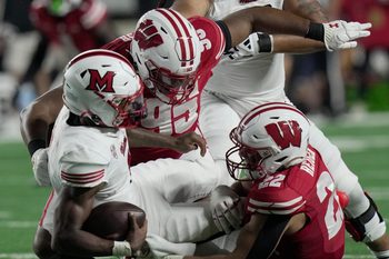 Miami (Ohio) quarterback Dequan Finn (1) is sacked by Wisconsin defensive lineman Brandon Lane (95) and linebacker Mason Reiger (22) during the second quarter of their game Thursday, August 28, 2025 at Camp Randall Stadium in Madison, Wisconsin.