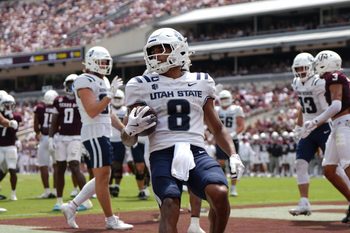 Sep 6, 2025; College Station, Texas, USA; Utah State Aggies running back Javen Jacobs (8) runs the ball to score a two-point conversion during the second half against the Texas A&M Aggies at Kyle Field. Mandatory Credit: Sean Thomas-Imagn Images