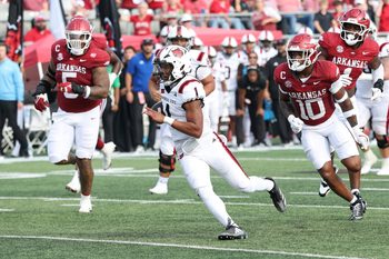 Sep 6, 2025; Little Rock, Arkansas, USA; Arkansas Razorbacks quarterback Jaylen Raynor (1) rushes in the second quarter against the Arkansas State Red Wolves at War Memorial Stadium. Mandatory Credit: Nelson Chenault-Imagn Images