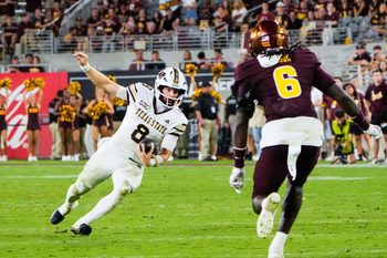 Sep 13, 2025; Tempe, Arizona, USA; Texas State Bobcats quarterback Brad Jackson (8) attempts to avoid a tackle by Arizona State Sun Devils safety Adrian Wilson (6) at Mountain America Stadium. Mandatory Credit: Arianna Grainey-Imagn Images