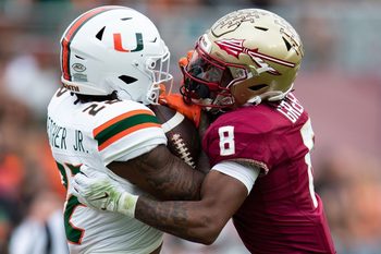 Florida State defensive back Renardo Green (8) tackles Miami running back Mark Fletcher Jr. (22) during a college football game Saturday, Nov. 11, 2023, at Doak Campbell Stadium in Tallahassee, Florida.