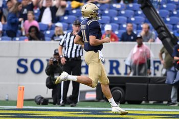 Sep 27, 2025; Annapolis, Maryland, USA;  Navy Midshipmen quarterback Blake Horvath (11) scores a first half touchdown against the Rice Owls at Navy-Marine Corps Memorial Stadium. Mandatory Credit: Tommy Gilligan-Imagn Images