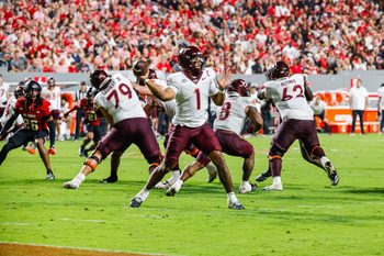 Sep 27, 2025; Raleigh, North Carolina, USA; Virginia Tech Hokies quarterback Kyron Drones (1) attempts to throw the ball during the first half of the game against North Carolina State Wolfpack at Carter-Finley Stadium. Mandatory Credit: Jaylynn Nash-Imagn Images