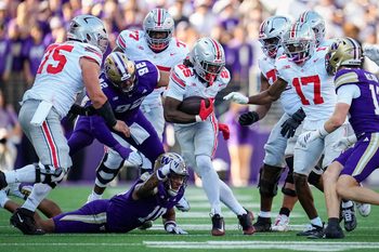 Ohio State Buckeyes running back Bo Jackson (25) runs over Washington Huskies linebacker Xe'ree Alexander (10) and defensive lineman Bryce Butler (92) during the NCAA football game at Husky Stadium in Seattle on Sept. 27, 2025. Ohio State won 24-6.