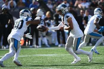 Sep 28, 2025; Foxborough, Massachusetts, USA; Carolina Panthers quarterback Bryce Young (9) hands the ball off to running back Chuba Hubbard (30) during the second half against the New England Patriots at Gillette Stadium. Mandatory Credit: Bob DeChiara-Imagn Images