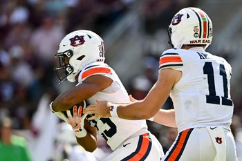 Sep 27, 2025; College Station, Texas, USA; Auburn Tigers quarterback Jackson Arnold (11) hands off the ball to running back Jeremiah Cobb (23) during the first half against the Texas A&M Aggies at Kyle Field. Mandatory Credit: Maria Lysaker-Imagn Images