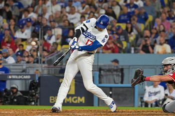 Sep 30, 2025; Los Angeles, California, USA; Los Angeles Dodgers designated hitter Shohei Ohtani (17) hits a two run home run during the sixth inning against the Cincinnati Reds during game one of the Wildcard round for the 2025 MLB playoffs at Dodger Stadium. Mandatory Credit: Jayne Kamin-Oncea-Imagn Images