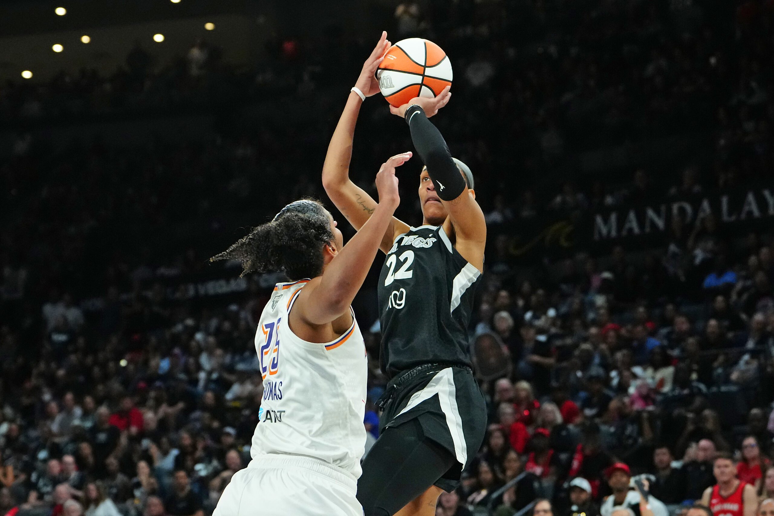 Oct 3, 2025; Las Vegas, Nevada, USA; Las Vegas Aces center A'ja Wilson (22) shoots against Phoenix Mercury forward Alyssa Thomas (25) during the fourth quarter of game one of the 2025 WNBA Finals at Michelob Ultra Arena. Mandatory Credit: Stephen R. Sylvanie-Imagn Images