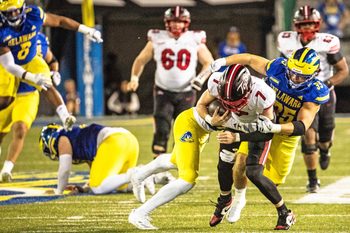 Western Kentucky quarterback Maverick McIvor (7) hangs on to the ball as Delaware Blue Hens safety KT Seay (7) and linebacker Gavin Moul (35) wrap him up for the takedown during Delaware's first home CUSA football game, which was nationally televised, at Delaware Stadium in Newark on Oct. 3, 2025. Western Kentucky won 27-24.