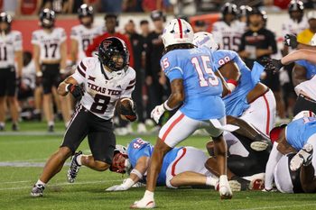 Oct 4, 2025; Houston, Texas, USA; Texas Tech Red Raiders running back Cameron Dickey (8) rushes against Houston Cougars defensive back Will James (15) in the second half at TDECU Stadium. Mandatory Credit: Thomas Shea-Imagn Images