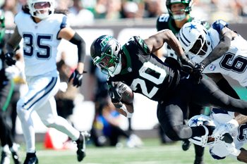 New York Jets running back Breece Hall (20), is tackled by the Dallas defense, Sunday, October 5, 2025.