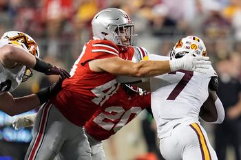 Ohio State Buckeyes defensive lineman Logan George (48) tackles Minnesota Golden Gophers running back Fame Ijeboi (7) during the NCAA football game at Ohio Stadium in Columbus on Oct. 4, 2025.