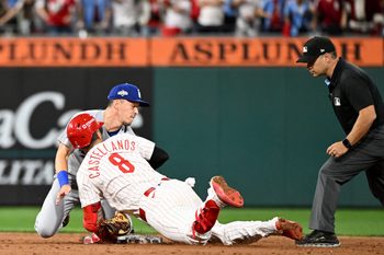 Oct 6, 2025; Philadelphia, Pennsylvania, USA; Philadelphia Phillies right fielder Nick Castellanos (8) slides into second base safely against Los Angeles Dodgers second baseman Tommy Edman (25) in the ninth inning during game two of the NLDS round for the 2025 MLB playoffs at Citizens Bank Park. Mandatory Credit: Eric Hartline-Imagn Images