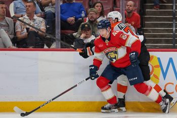 Oct 9, 2025; Sunrise, Florida, USA; Florida Panthers defenseman Gustav Forsling (42) moves the puck against Philadelphia Flyers right wing Tyson Foerster (71) during the third period at Amerant Bank Arena. Mandatory Credit: Sam Navarro-Imagn Images
