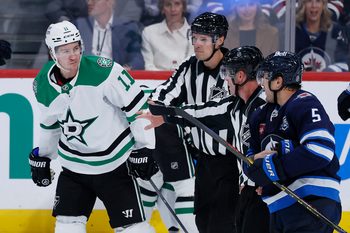 Oct 9, 2025; Winnipeg, Manitoba, CAN; Dallas Stars right wing Nathan Bastian (11) and Winnipeg Jets defenseman Luke Schenn (5) are separated during an altercation in the third period at Canada Life Centre. Mandatory Credit: James Carey Lauder-Imagn Images