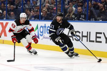 Oct 11, 2025; Tampa, Florida, USA; Tampa Bay Lightning center Brayden Point (21)] skates with the puck as New Jersey Devils defenseman Luke Hughes (43) defends during the first period at Benchmark International Arena. Mandatory Credit: Kim Klement Neitzel-Imagn Images