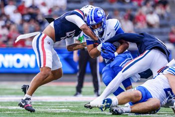 Oct 11, 2025; Tucson, Arizona, USA; Brigham Young Cougars running back LJ Martin (4) gets tackled by Arizona Wildcats defensive back Dalton Johnson (43) during the first quarter of the game at Arizona Stadium. Mandatory Credit: Aryanna Frank-Imagn Images