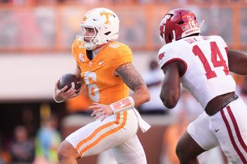 Arkansas wide receiver Raylen Sharpe (6) runs the ball as Arkansas linebacker Stephen Dix Jr. (14) pursues in an NCAA college football game on Oct. 11, 2025, in Knoxville, Tennessee.