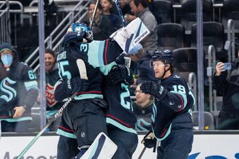 Oct 11, 2025; Seattle, Washington, USA; Seattle Kraken forward Jared McCann (19) celebrates with defenseman Joey Daccord (35) and defenseman Vince Dunn (29) after scoring a goal in overtime against against the Vegas Golden Knights at Climate Pledge Arena. Mandatory Credit: Stephen Brashear-Imagn Images